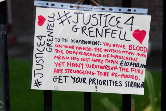 London, United Kingdom, 14th April 2018:- Banners near the ruins of Grenfell tower ten months on from the devastating fire that killed 71 in Kensington and Chelsea