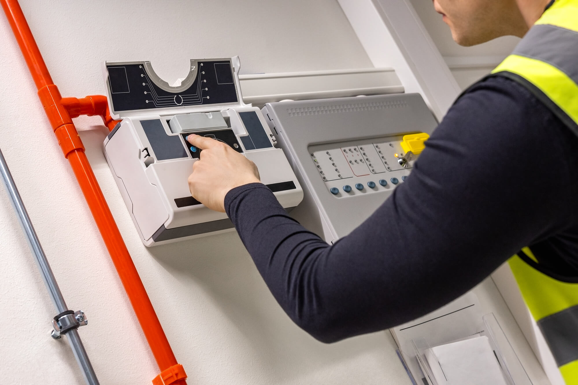 fire sprinkler engineer inspecting panel for reliability